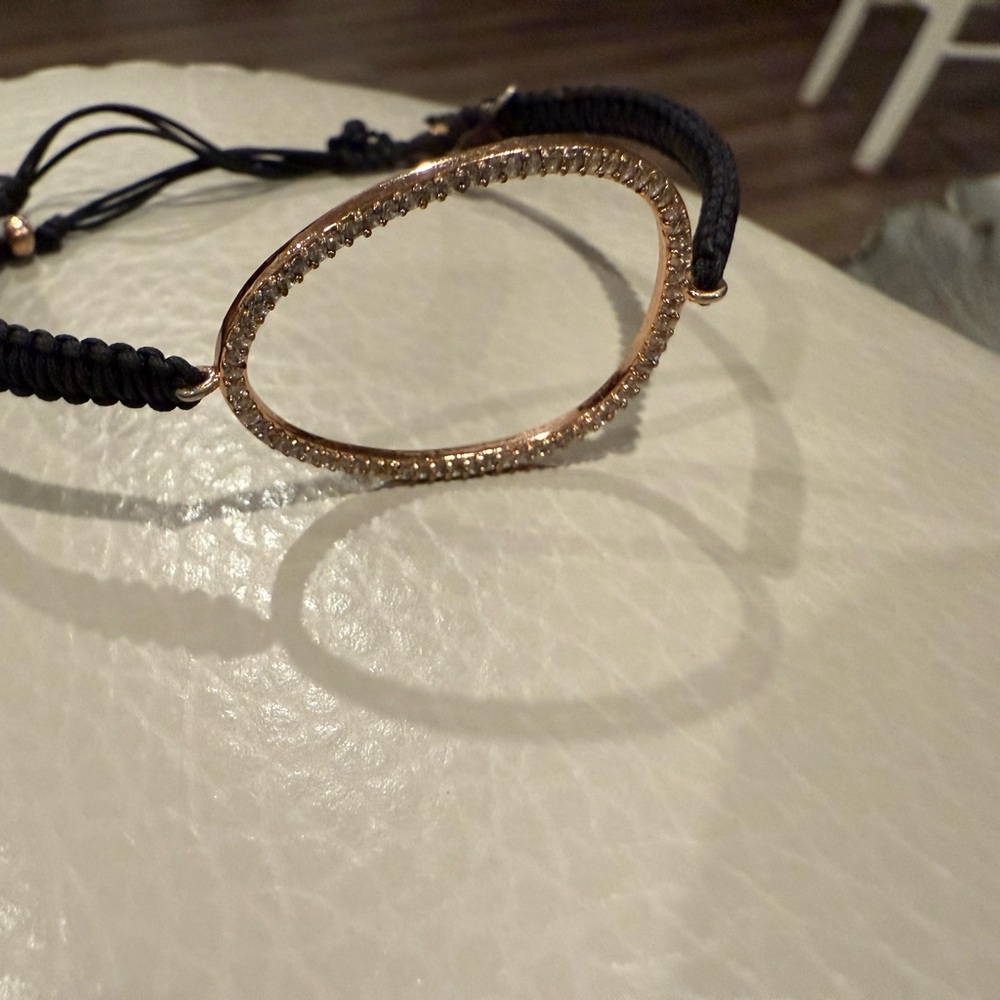 Tai Gold and Black Bracelet with Open Curved Design and Sparkling Texture